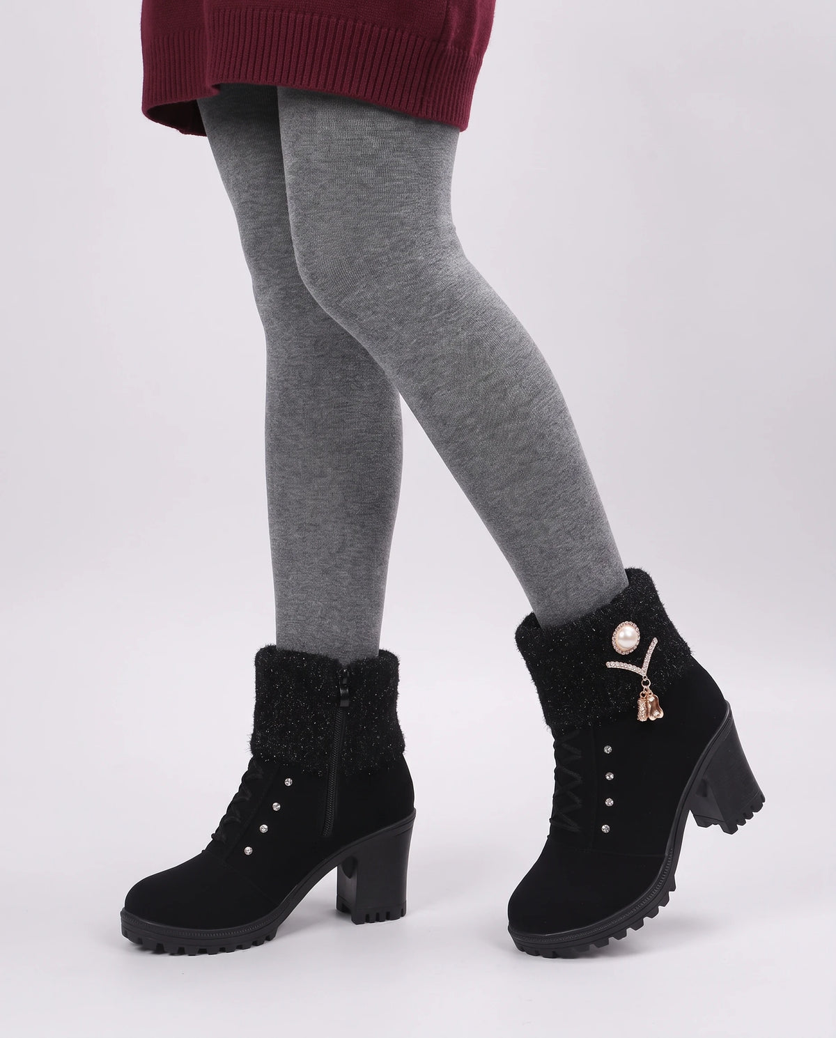 Bottines fourrées à talon et revers en maille Lucrèce — Noir, portées en plan rapproché sur collants gris, revers replié