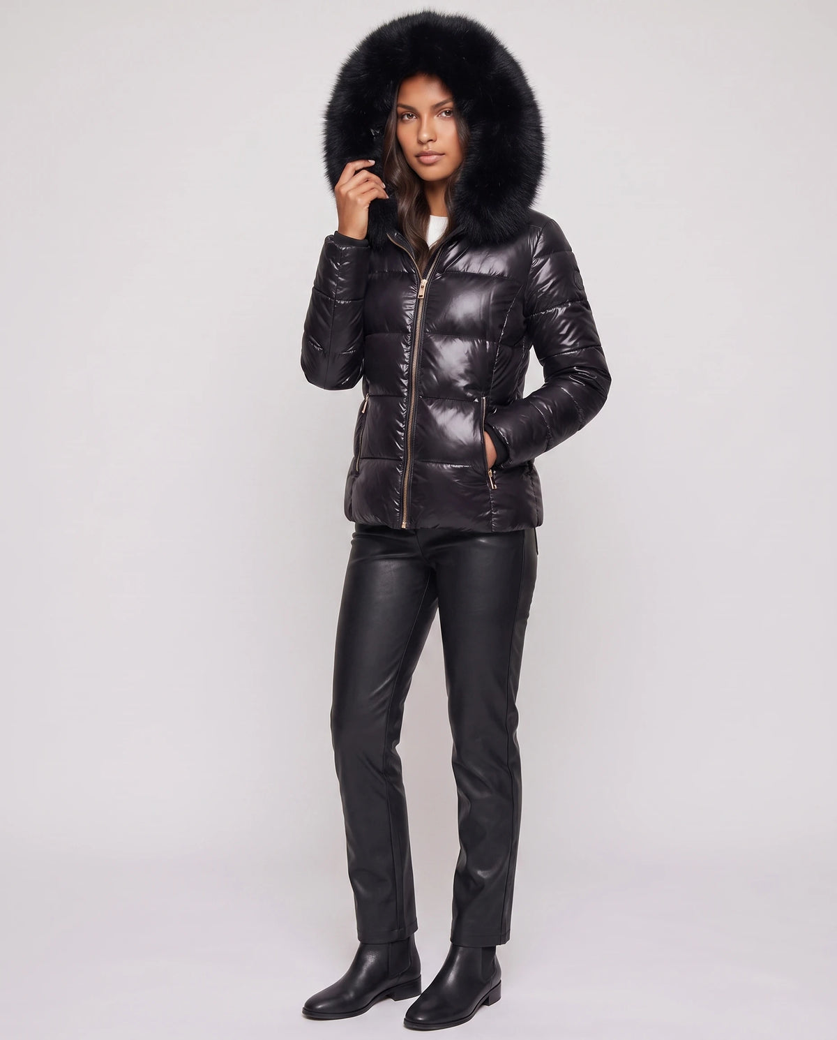 Kurze glänzende Steppjacke mit Kunstfellkapuze Victoria in Schwarz, Dreiviertelansicht, grosse Kunstfellkapuze aufgesetzt