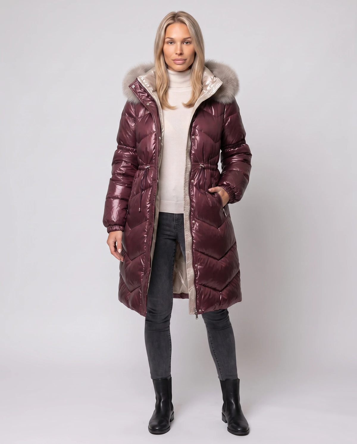 Glänzende mittellange Steppjacke mit Kunstfellkapuze Karine in Bordeaux, offen getragen über ecrufarbenem Rollkragen, Champagnerfutter sichtbar