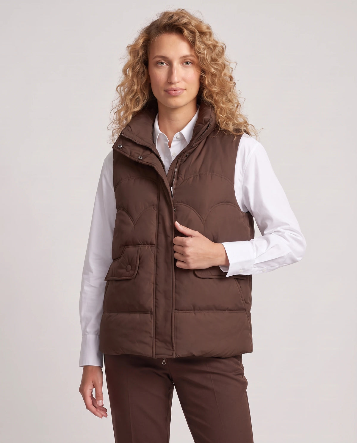 Gilet matelassé court à col montant Sylvie en Chocolat Foncé, plan rapproché, col ouvert, mains dans les poches à rabat