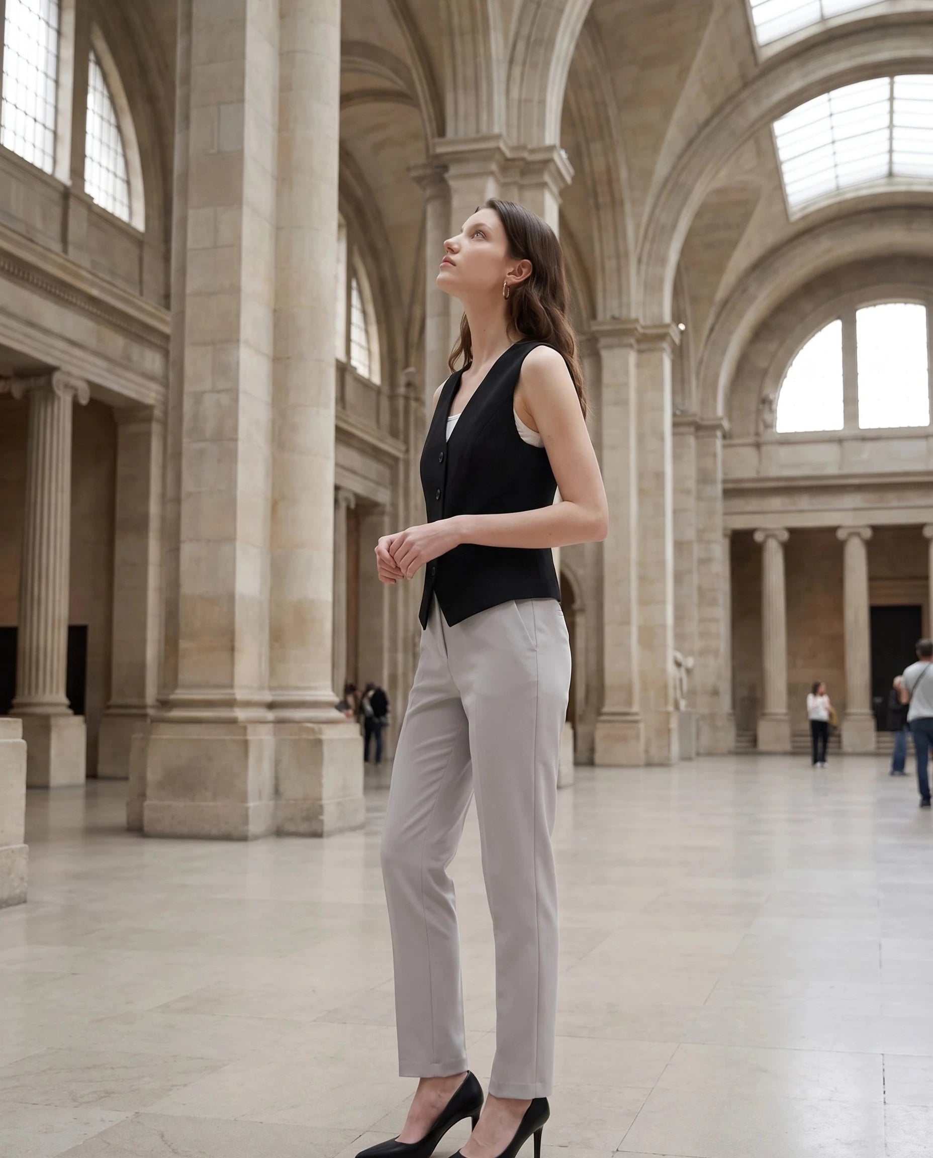 Gilet de tailleur noir Marthe, porté dans une galerie de musée lumineuse