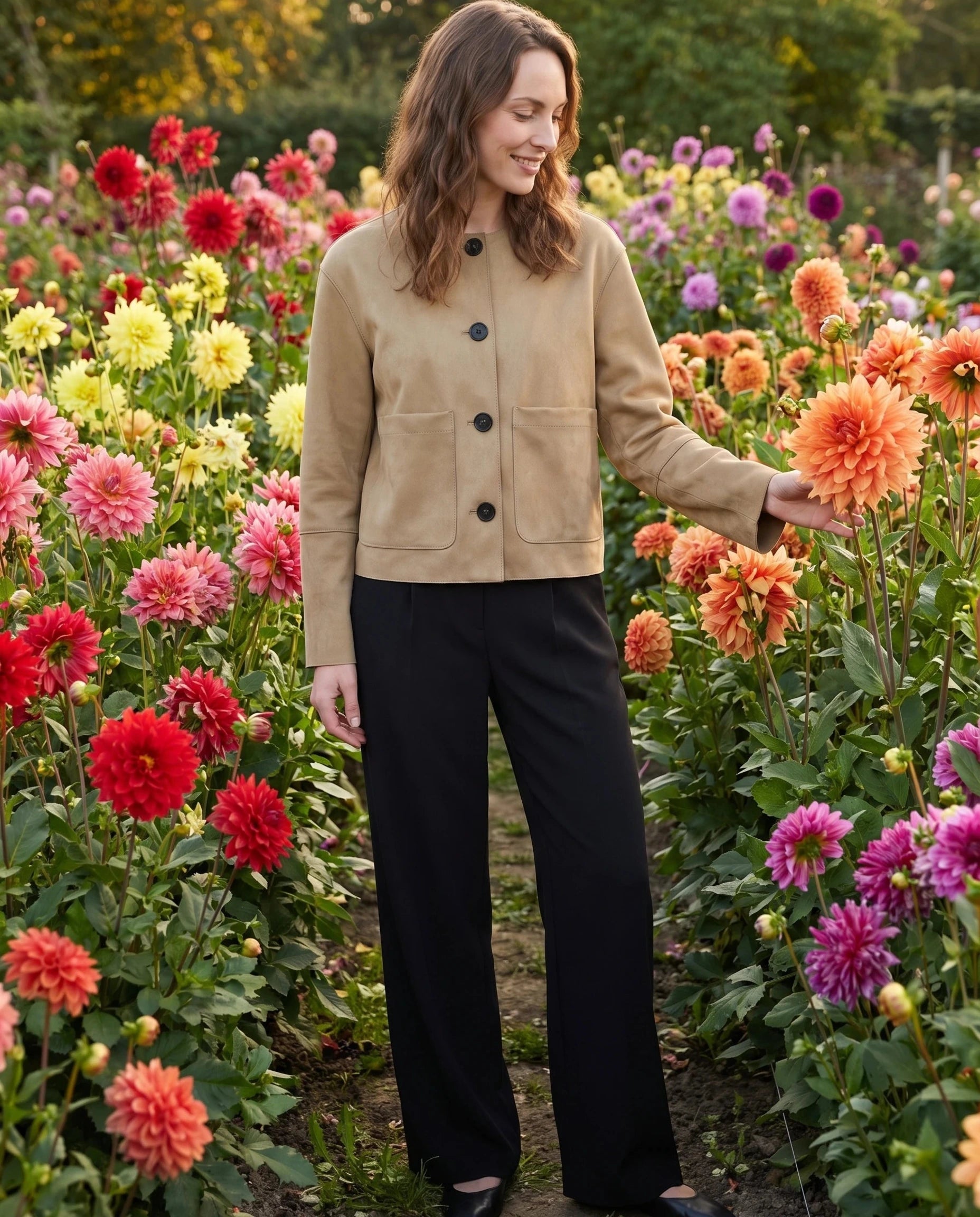 Veste sans col en suédine sable Andrée, portée dans un jardin de dahlias