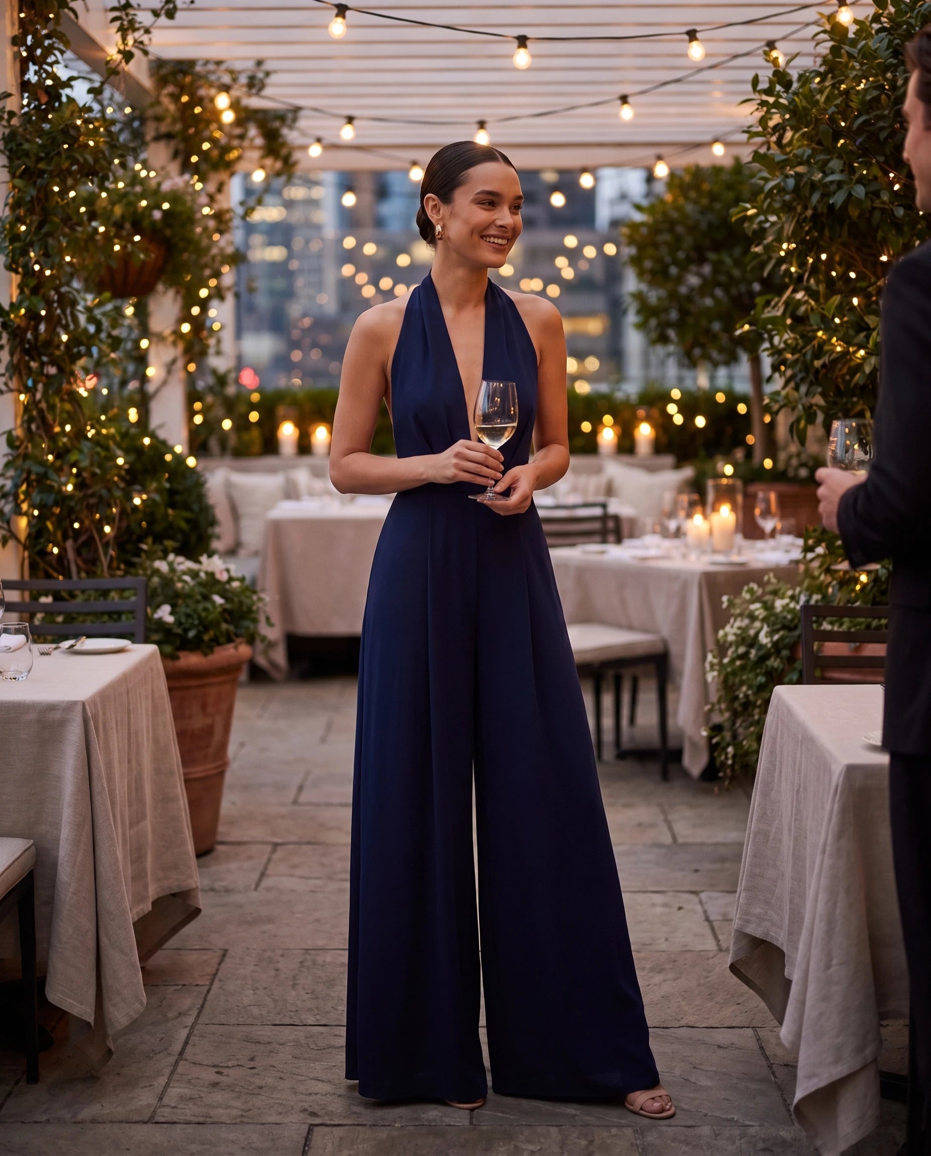 Combinaison habillee dos nu jambe large Bleu Marine portee sur une terrasse de restaurant le soir - Celestine | Zolena